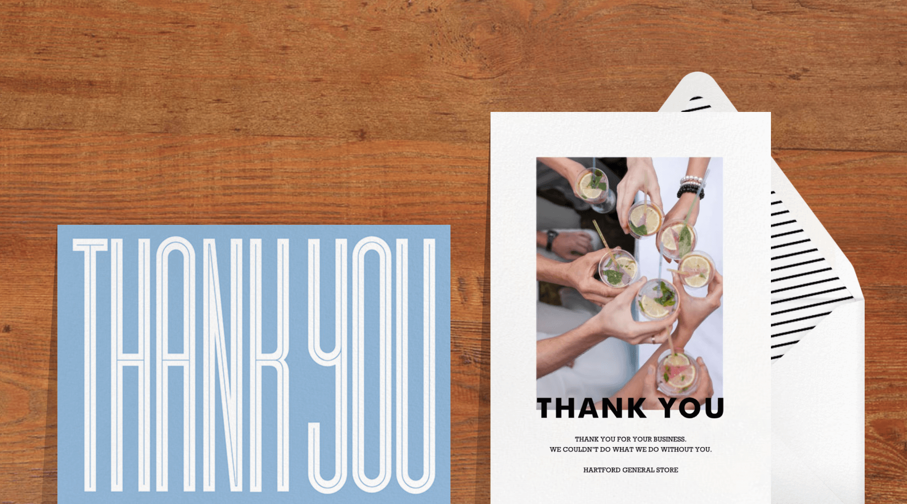 Two thank you cards over a wooden background.